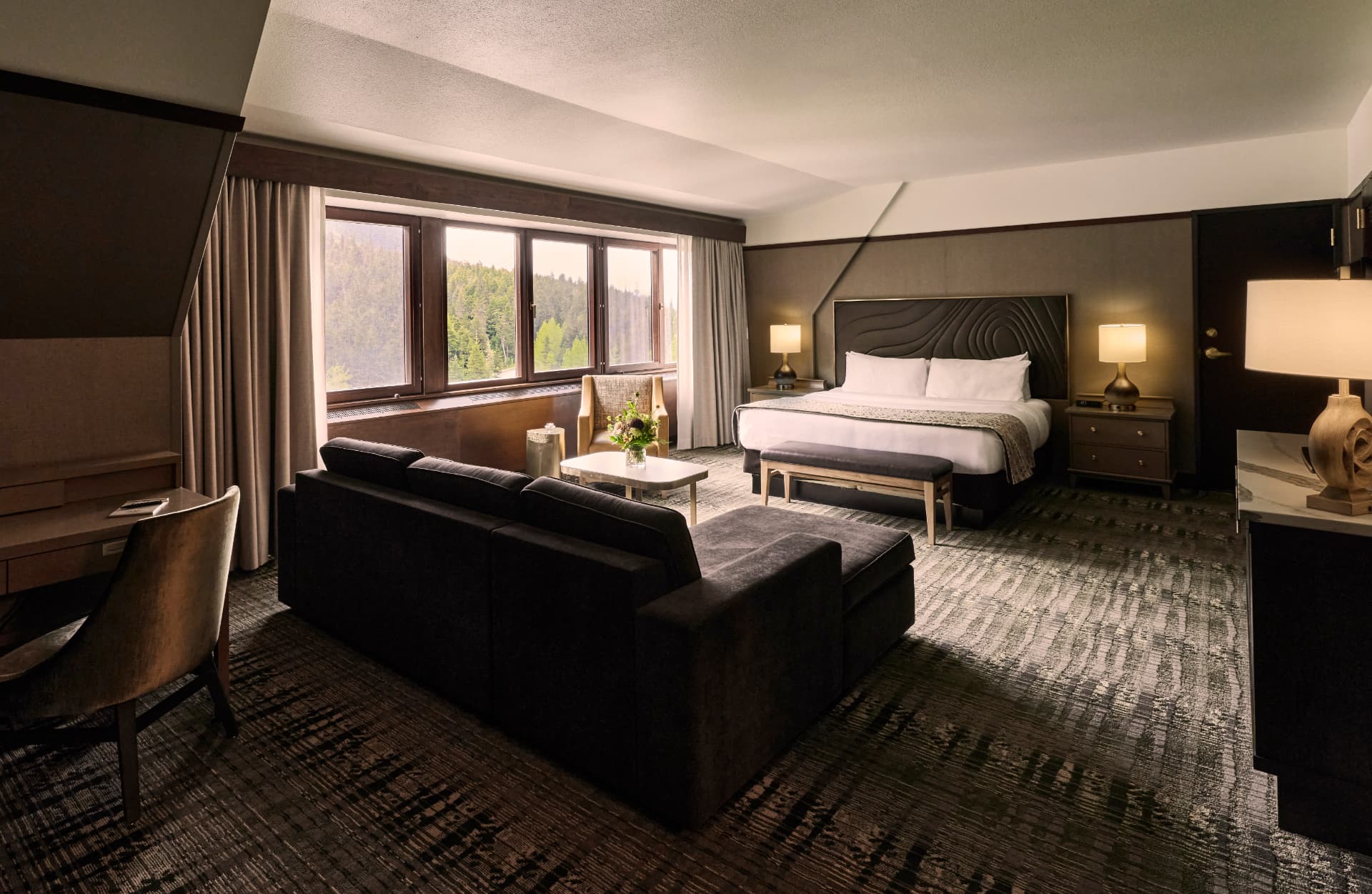 Executive suite with a sitting area and king bed at The Hotel Alyeska