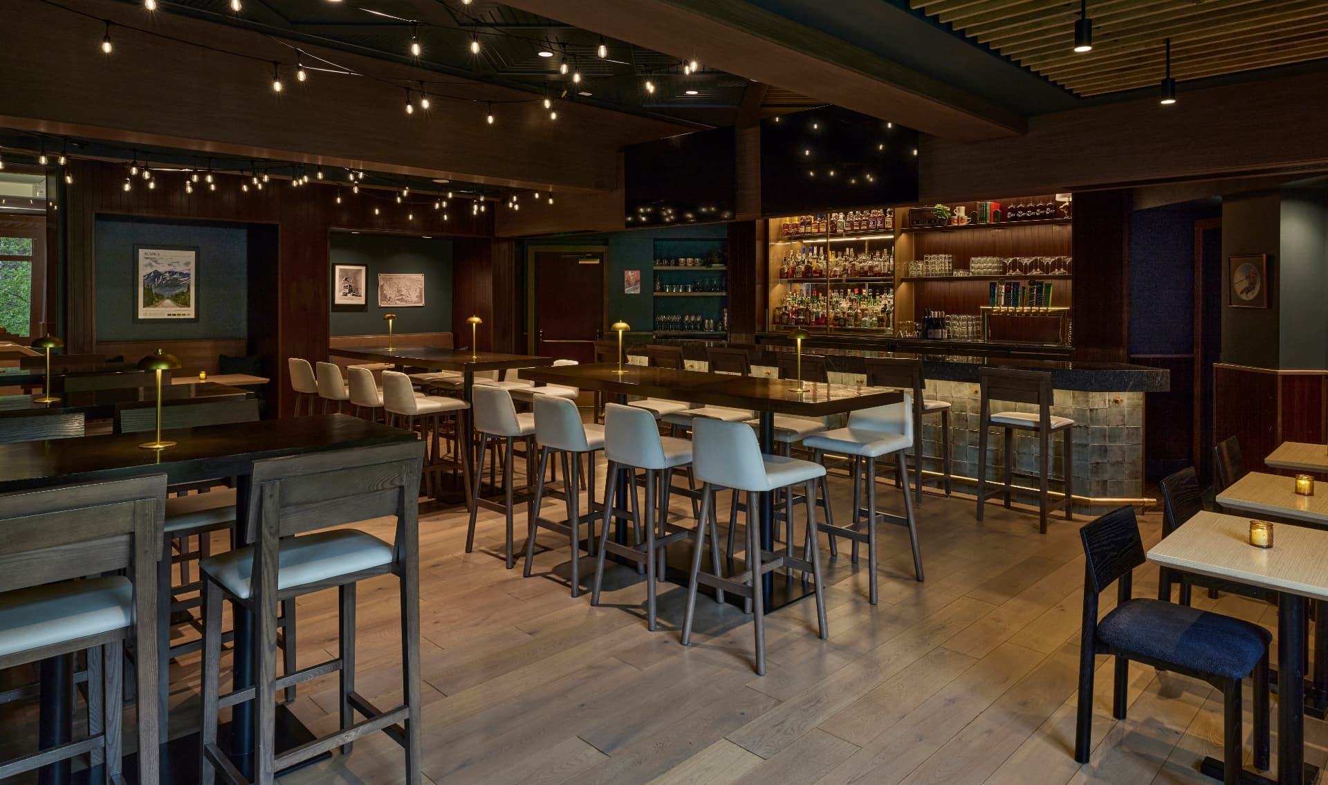 aBar at The Hotel Alyeska with string lights and high top tables