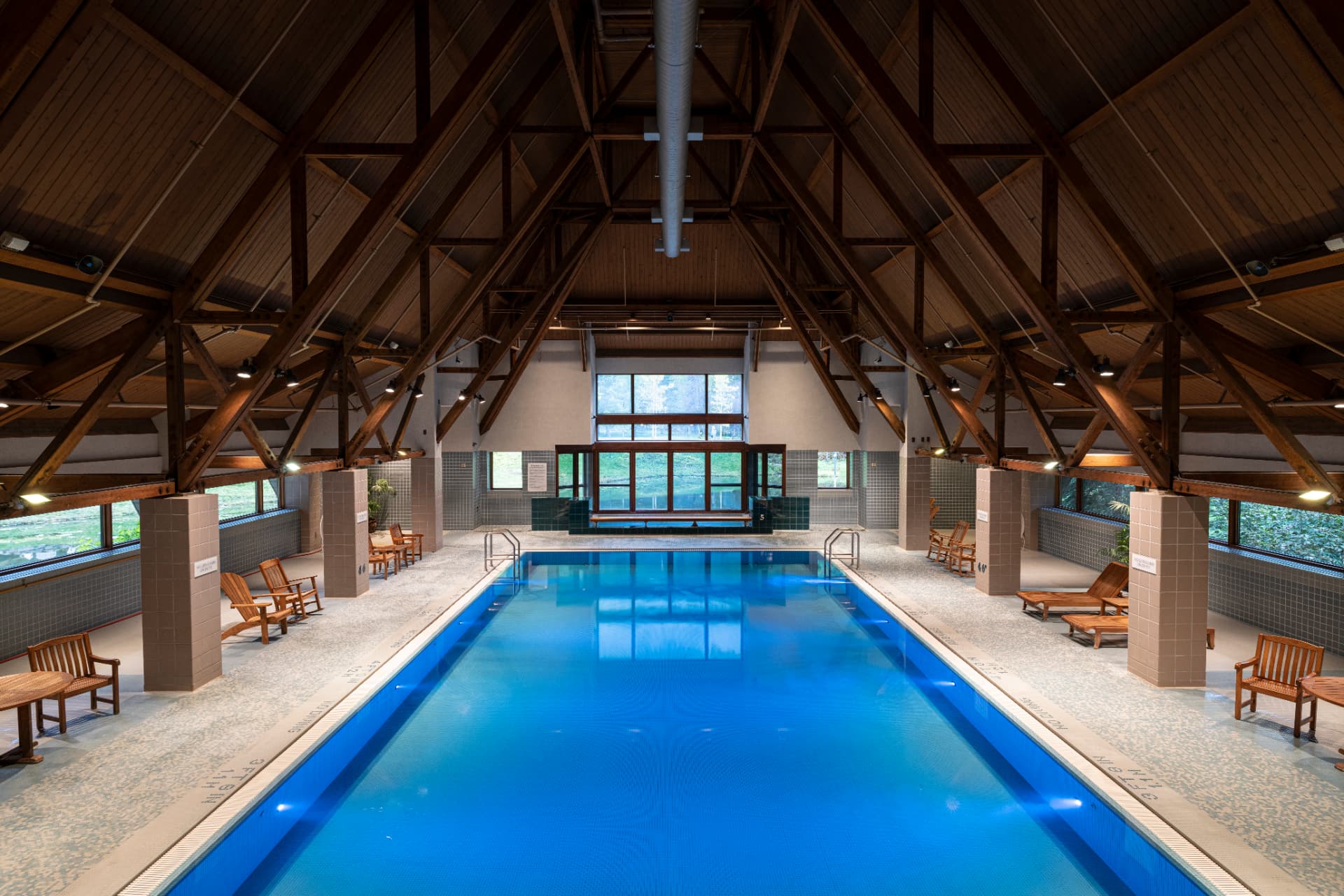 Indoor saltwater lap pool under timber trusses at The Hotel Alyeska