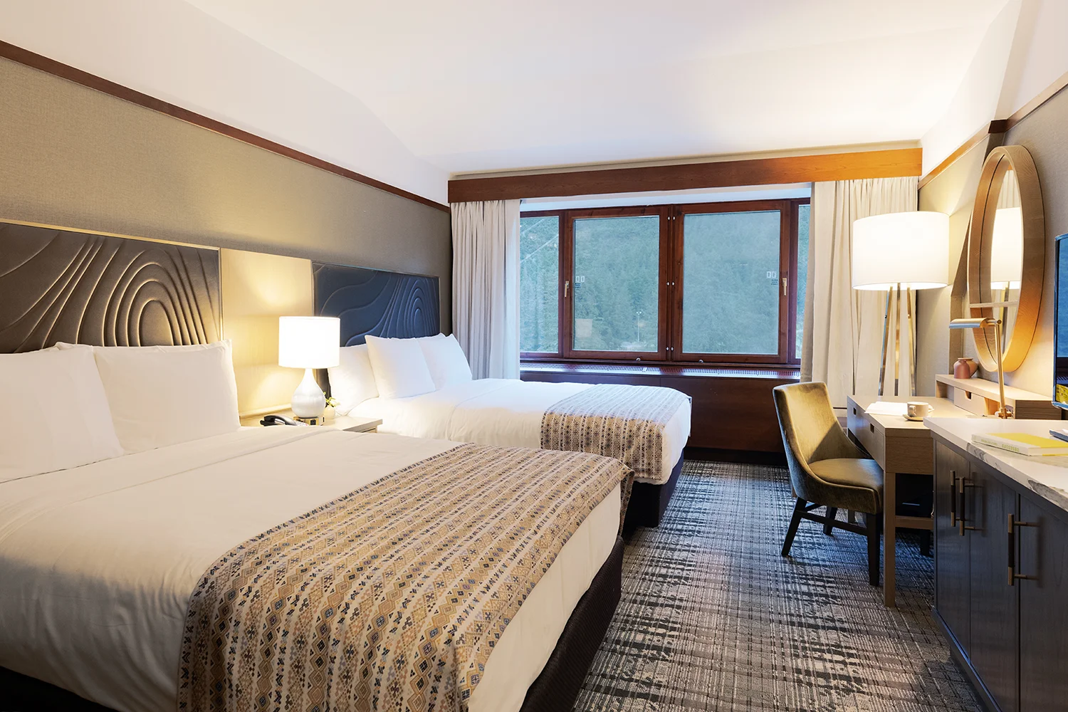 Signature guest room with two queen beds and a forest view at The Hotel Alyeska