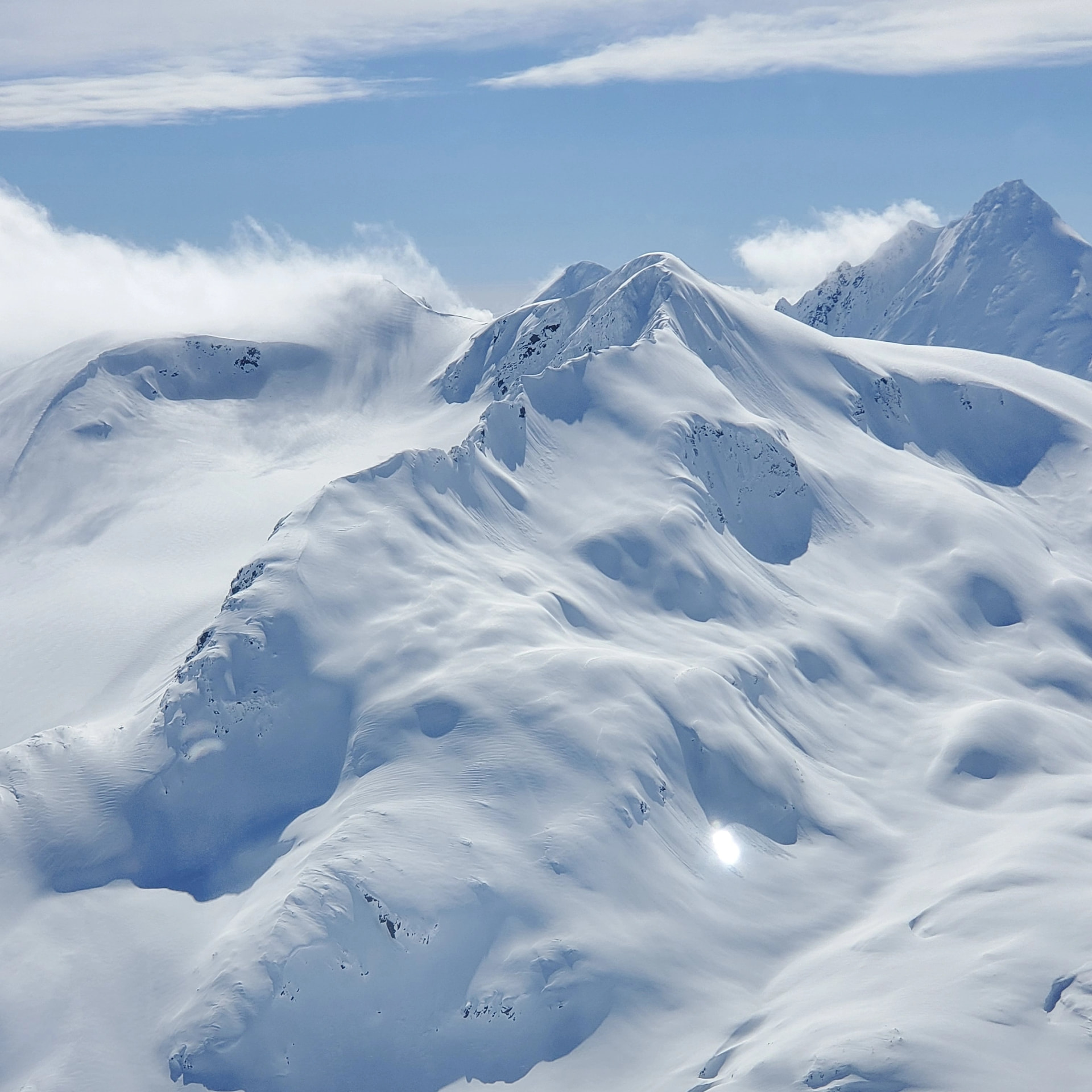 Snow covered Alaskan valley and small mountain community seen from the air