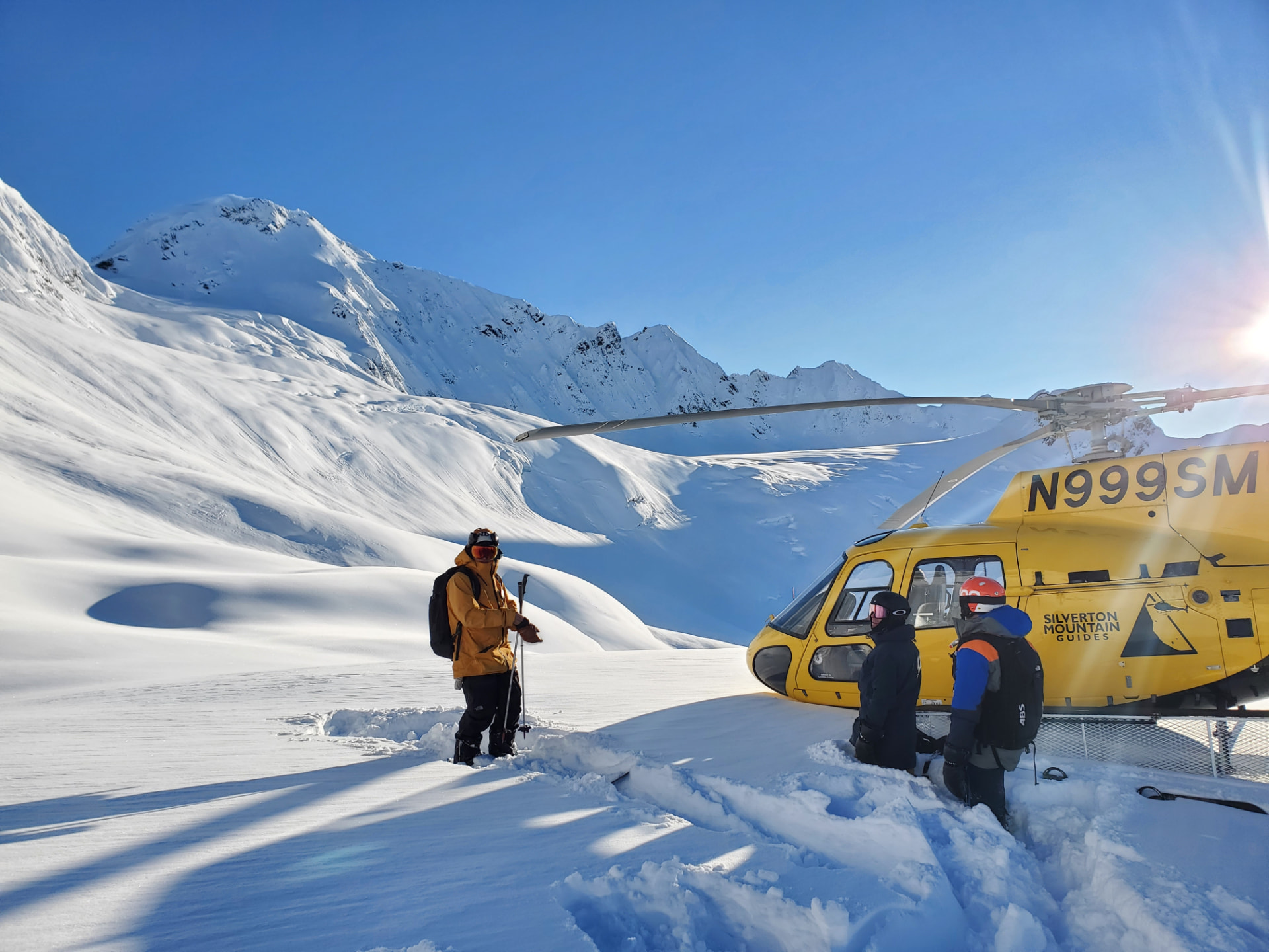 SMG helicopter and guides with guests in the Northern Chugach mountains of Alaska