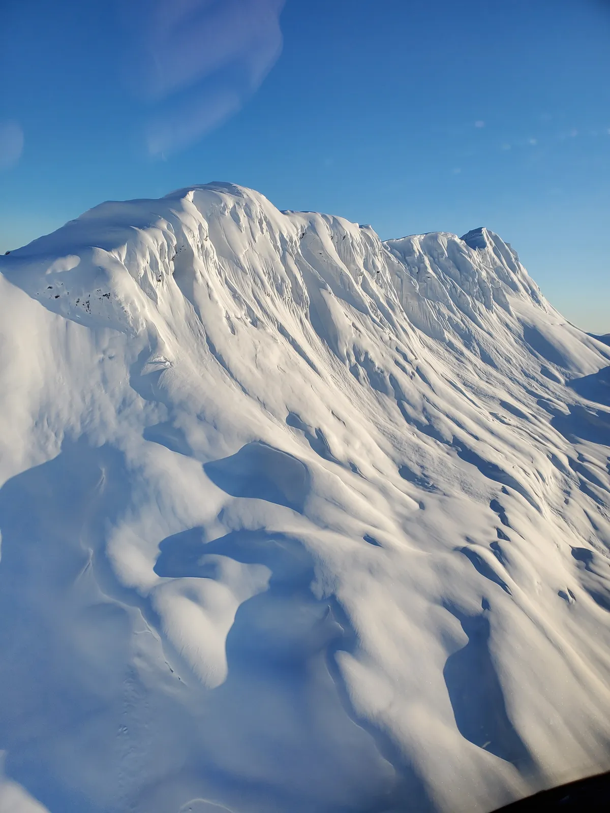 Snow-covered Alaska mountain peaks seen from the SMG helicopter